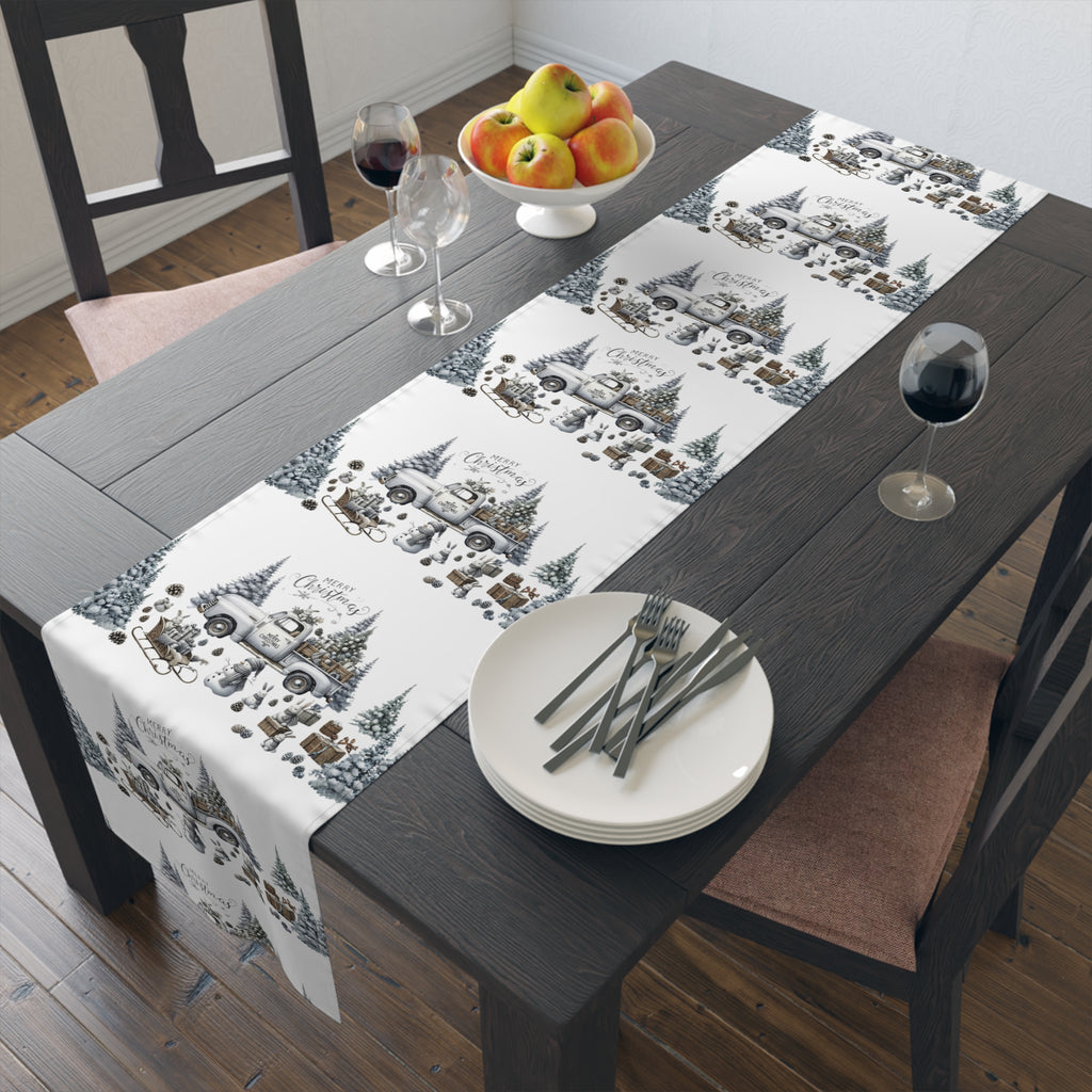 Dining table set with a decorative truck table runner, plates, and cutlery.