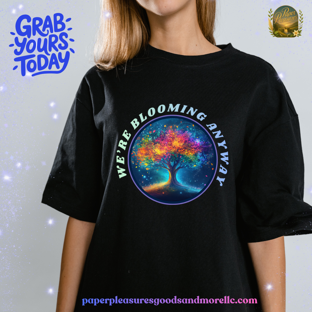 Person wearing a black t-shirt with a colorful tree design and text, on a light gray background.